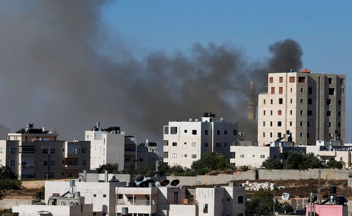 Smoke rises during an Israeli military operation in the West Bank city of Hebron September 23, 2014.