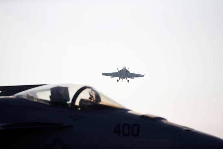 A U.S. Navy F/A-18 Super Hornet fighter lands onto the deck of the USS Ronald Reagan. 