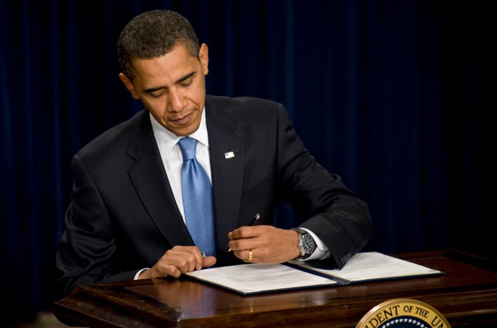 President Barack Obama signs an executive order on ethics for his senior staff during a meeting in the Eisenhower Executive Office Building, adjacent to the White House, in Washington, D.C. on Jan. 21, 2009.