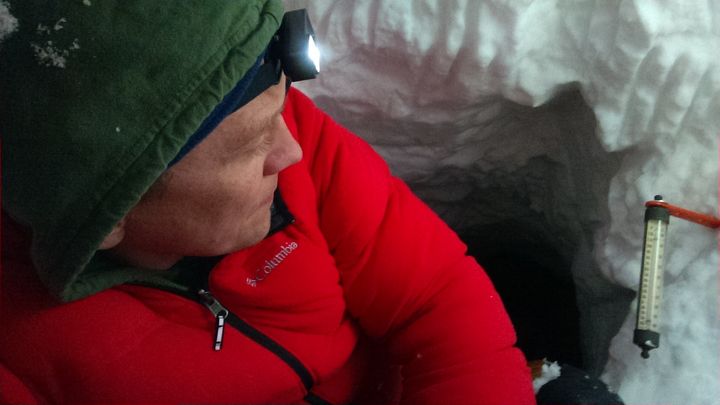 Spending the night in a frozen snow cave.