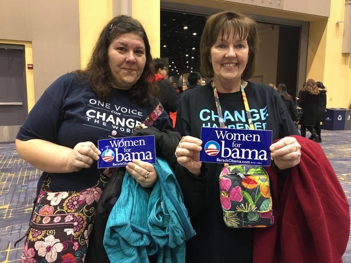 Andrea and Carol Bercos, in the shirts they wore at President Barack Obama's 2008 election night victory celebration in Chicago, hold bumper stickers from 2008 during the president's farewell address, Jan. 10, 2017.