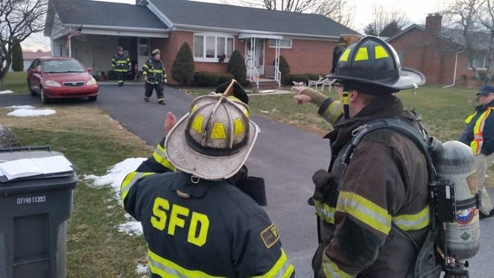 Fire Chief Randy O’Donnell of Shippensburg, Pennsylvania, left, discusses the plan for clearing smoke from a house. All-volun