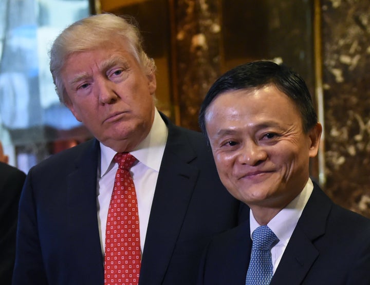 Jack Ma (R), founder and executive chairman of Alibaba Group, and President-elect Donald Trump pose for the media after their