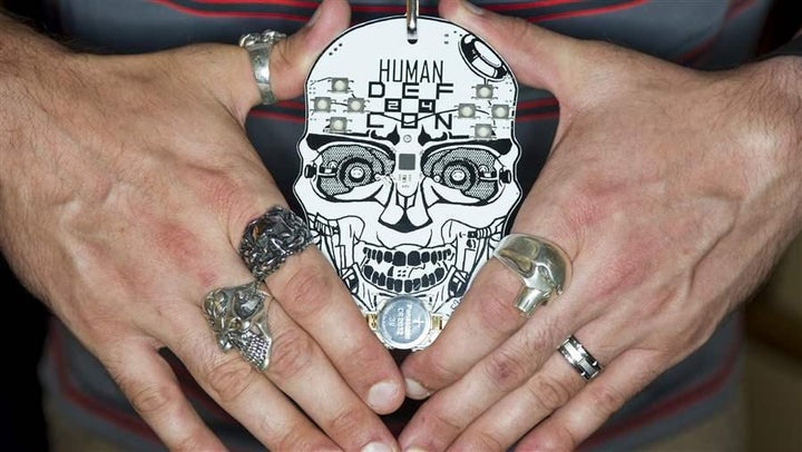 An attendee shows off his electronic badge in August in Las Vegas at one of the world’s largest hacker conventions. Hacktivists, who blend hacking and activism for political and social causes, are increasingly attacking government computer networks.