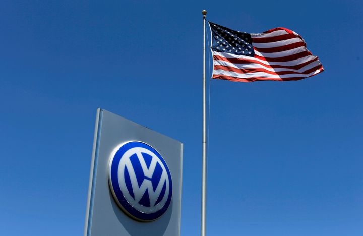A U.S. flag flutters in the wind above a Volkswagen dealership in Carlsbad, California, U.S. May 2, 2016.