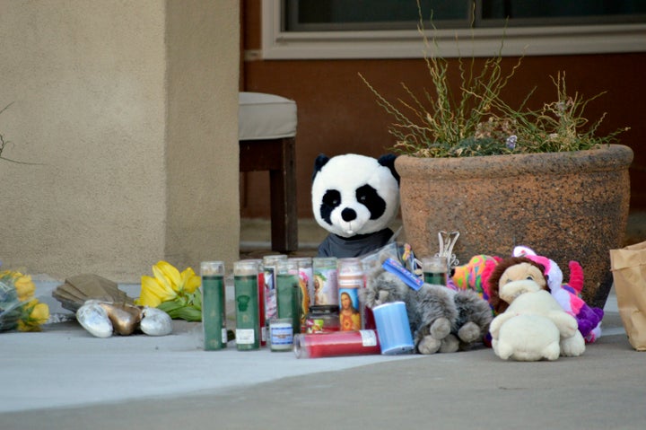 Candles and stuffed animals left by neighbors rest outside an Albuquerque, N.M., home Dec. 7, 2016, after a deadly shooting.