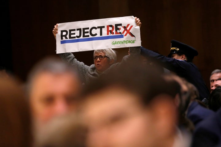 Protesters interrupted the proceedings at least four times by holding up signs with the words “Reject Rexx” written in the same font as Exxon Mobil’s logo and shouting “oil is dead” and “please don’t put Exxon in charge of the State Department.” 