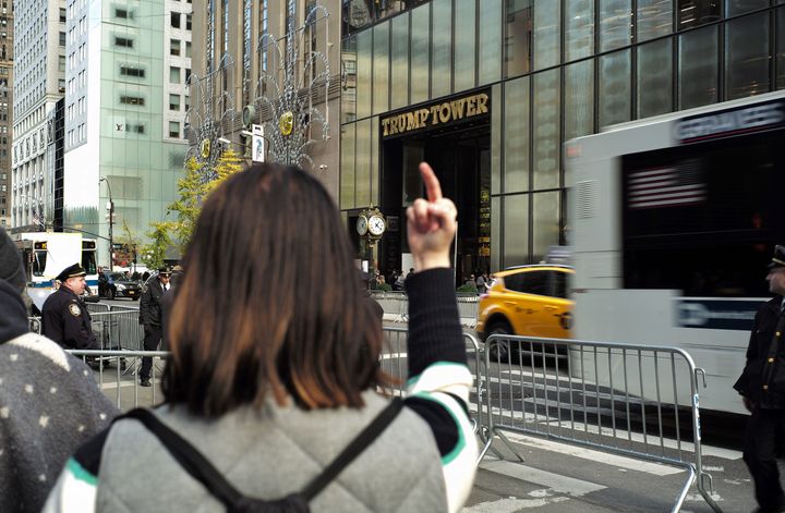 A protester gestures near the Trump Tower in New York City, where President-elect Donald Trump is holding meetings, on Nov. 14, 2016.