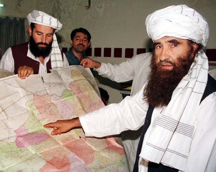 Jalaluddin Haqqani points to a map of Afghanistan during a visit to Islamabad, Pakistan, October 19, 2001.