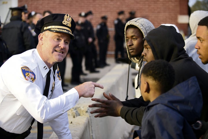 Captain Erik Pecha of the Baltimore Police Department chats with demonstrators in front of the Baltimore Police Department Western District station during a protest against the death in police custody of Freddie Gray in 2015. 