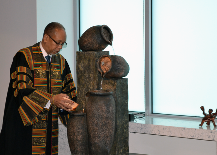 Rev. Dr. Dennis Wiley joins in a symbolic washing away of negativity around women’s reproductive decisions during an interfaith ceremony at the The Carol Whitehill Moses Center.