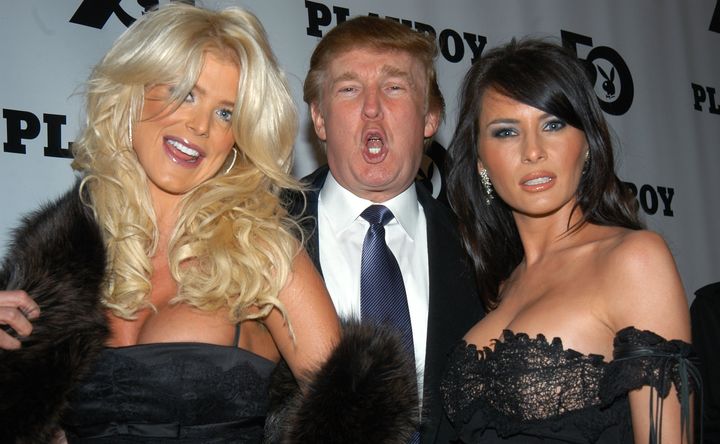 Donald Trump is flanked by Victoria Silvstedt, 1997 Playmate of the Year, and his then-girlfriend, Melania Knauss, at Playboy magazine's 50th anniversary celebration in 2003.