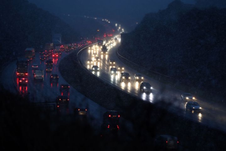 Cars make their way through snowy conditions on the M3 motorway near Winchester
