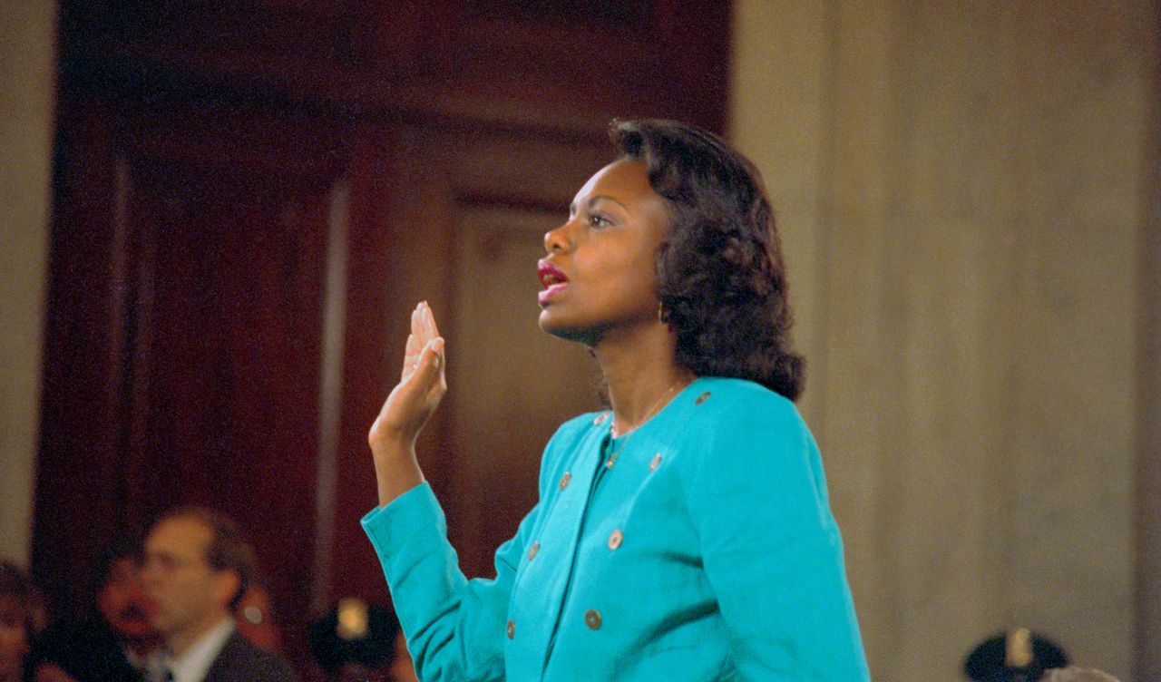 Anita Hill is sworn in before testifying. Hill worked with Clarence Thomas and alleged that he sexually harassed her.