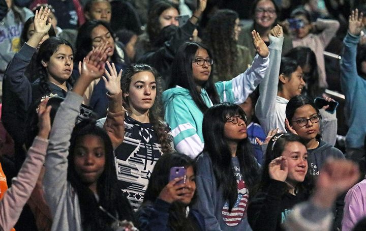 Middle and high school girls from across Los Angeles County raise their hands after musician Pharrell Williams asks who would consider a career in STEM. The girls had been invited to a screening of the film “Hidden Figures” at USC.