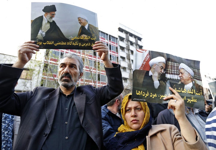 Iranians hold posters of late former Iranian President Akbar Hashemi Rafsanjani during his funeral ceremony in the capital Tehran, on Jan. 10, 2017.