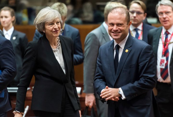 Theresa May, second left, speaks with Malta's Prime Minister Joseph Muscat, third right, during a round table meeting at an EU Summit in Brussels on Thursday, Dec. 15, 2016