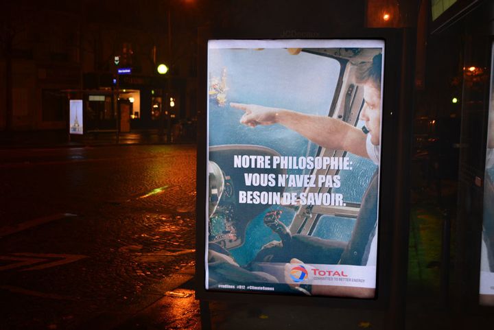 During the climate conference COP21, artists installed over 600 artworks in advertising spaces across Paris criticising corporate sponsors of the climate talks such as Total. Artwork by Barnbrook, Klink & Friends. 