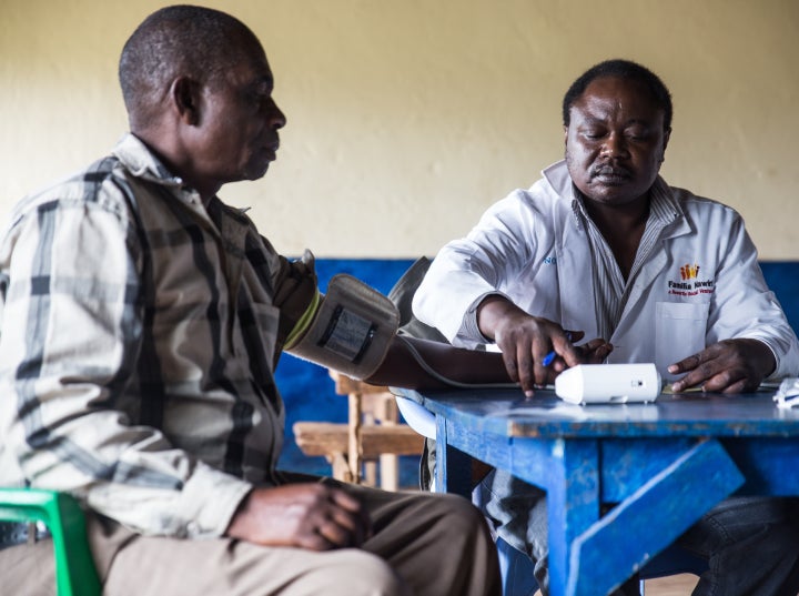 A patient at a rural health camp in Mwae County, Kenya has his blood pressure checked as part of a full physical exam. If needed, non-communicable disease drugs will be made available through Novartis Access, a new program to make NCD drugs available in developing countries.