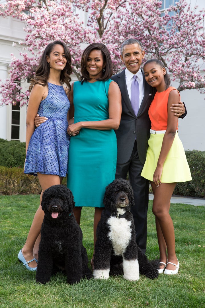 President Barack Obama, First Lady Michelle Obama, and daughters Malia and Sasha pose for a family portrait with their pets Bo and Sunny in the Rose Garden of the White House on Easter Sunday 2015.