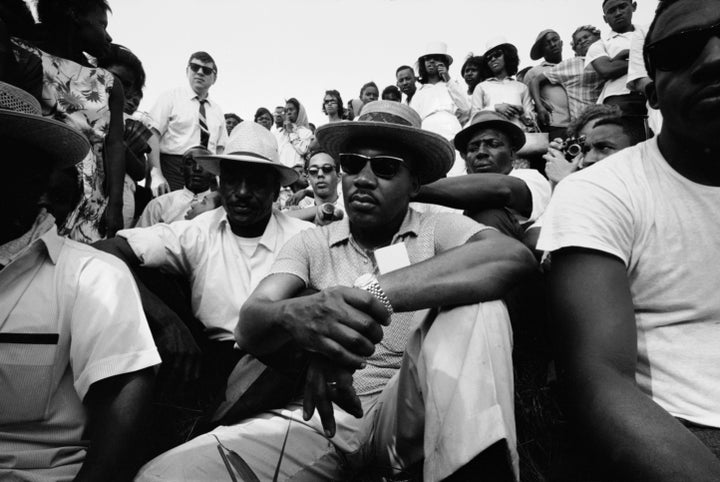 Dr. King sits with others during a march to encourage voter registration.