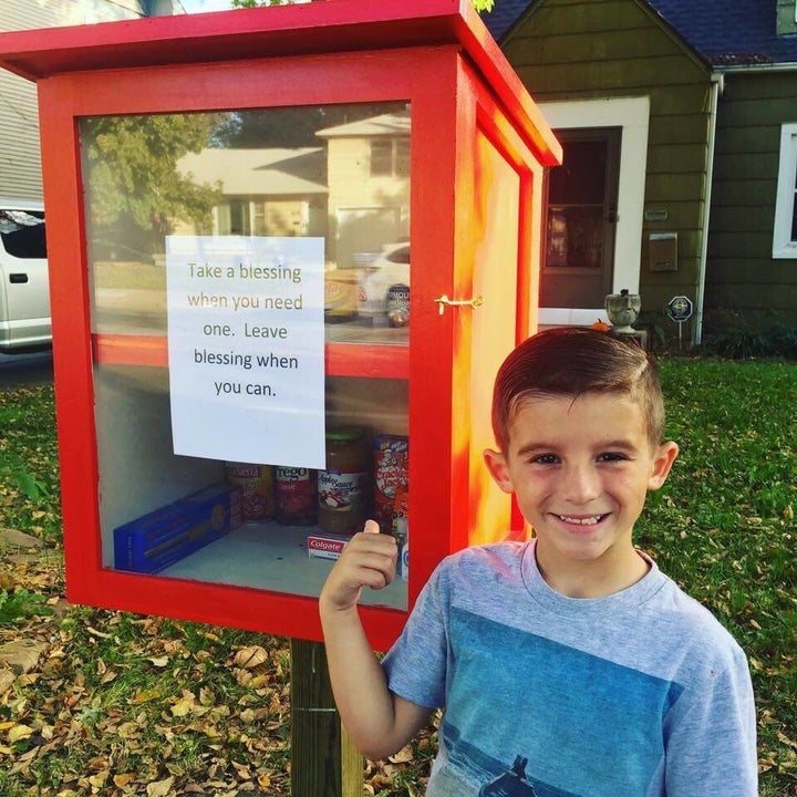 Maggie Ballard and her 6-year-old son Paxton helped stock their "blessing box" with food and hygienic products for people in need.