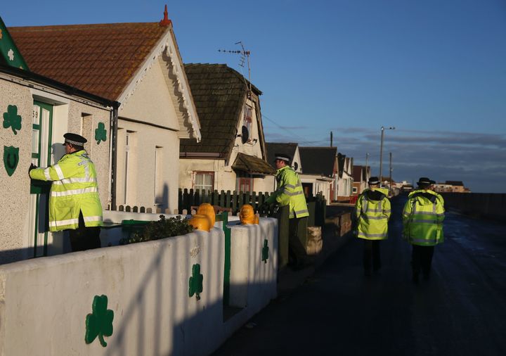Police officers go door to door giving information on flood risks to residents in Jaywick