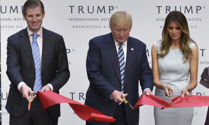 Eric, Donald and Melania Trump cut the ribbon at the grand opening of the Trump International Hotel in Washing
