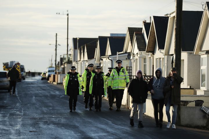 Police officers patrol the streets in Jaywick as residents prepared for a storm surge on Friday