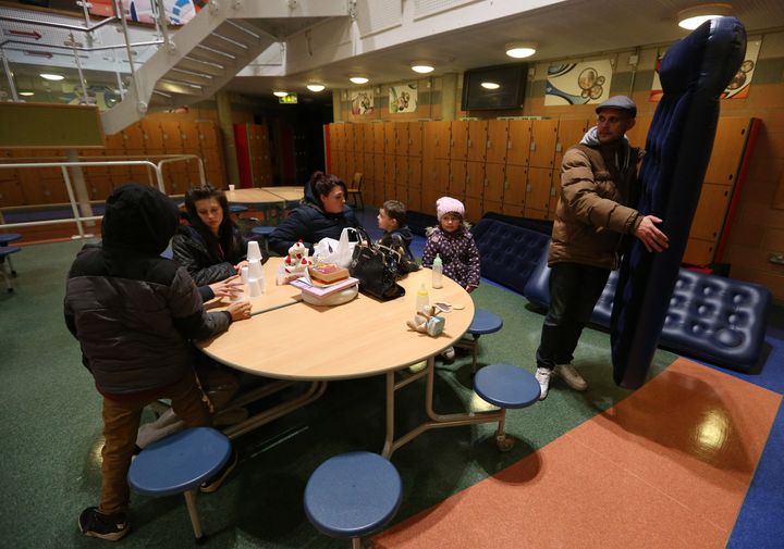 Gavin Mack (right) from St Osyth, prepares to bed down with his family at the Tendring Educational Centre in Jaywick, Essex after residents were evacuated over flooding fears 