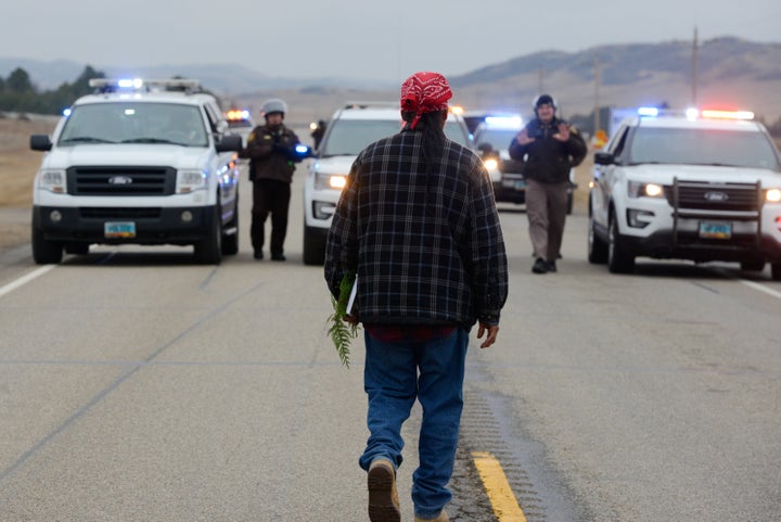 A protester blocks highway 1806 in Mandan during a protest against plans to pass the Dakota Access pipeline near the Standing Rock Indian Reservation, North Dakota, U.S. November 23, 2016. REUTERS/Stephanie Keith