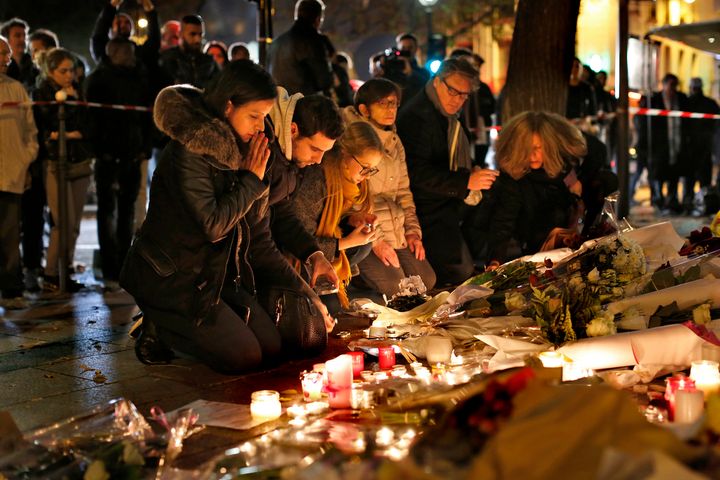 A crowd gathers at the Le Bataclan theatre to pay tribute and lay flowers for those who died in the terrorist attacks yesterday, Nov. 14, 2015 in Paris, France.