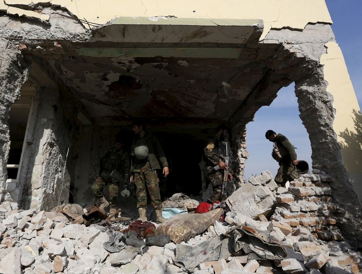 Afghan soldiers inspect a damaged building after a blast near the Pakistani consulate in Jalalabad on Jan. 13, 2016.