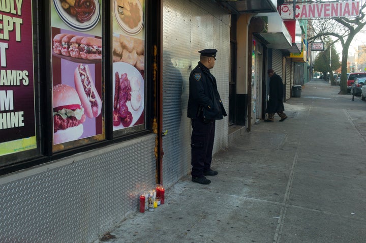 A police officer stationed on the street in the Bronx after a fatal shooting in November.