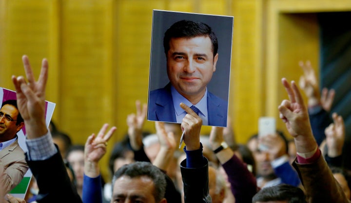A supporter holds a portrait of Selahattin Demirtas. 