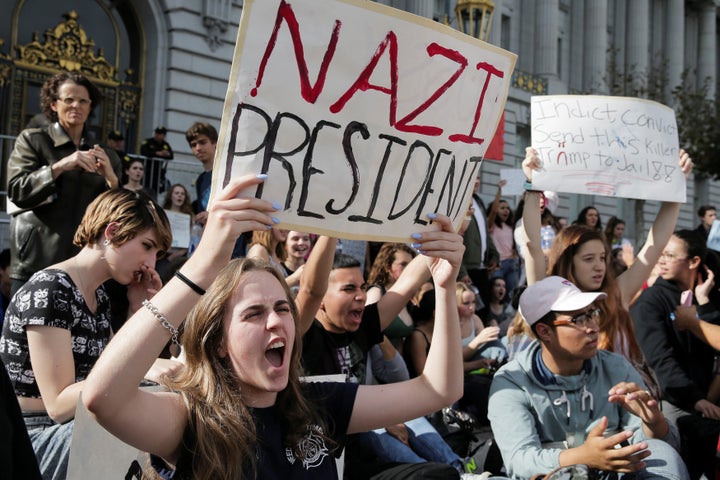 Hope Robertson, 17, of Mission High School, holds up a sign in front of San Francisco City Hall in protest of President-elect Donald Trump.