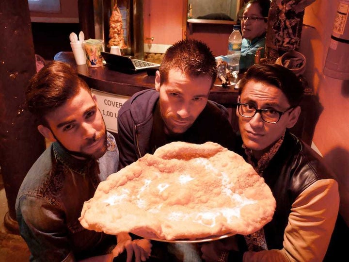 Sebastien about to try Ecuadorian empanada de viento with friends in Quito Old Town