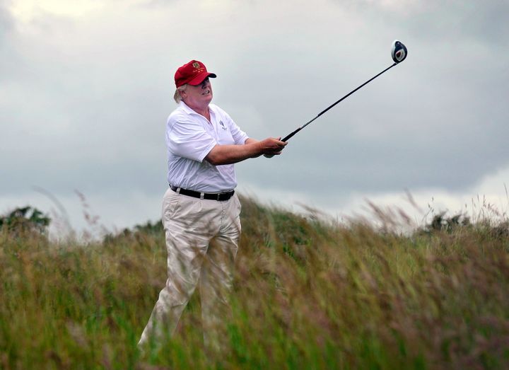Donald Trump plays a round in July 2012 when his opened his Trump International Golf Links course in Aberdeenshire, Scotland. Now he's proceeding with expanding the resort despite last week's promise that his company wouldn't be involved in any new private business deals abroad.