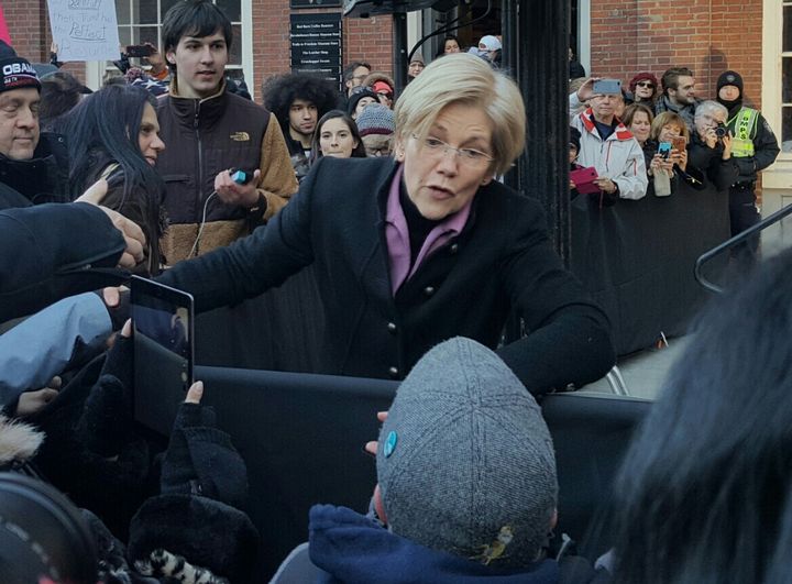 Sen. Elizabeth Warren greets audience members at Jan. 15 Boston rally for the ACA.