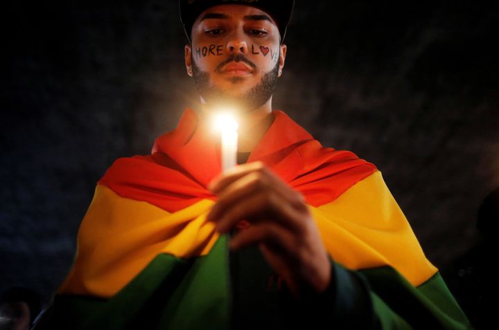 A man holds a candle during a vigil in Sao Paulo, Brazil, in memory of the victims of the Pulse gay nightclub shooting in Orlando, Florida, June 15, 2016.