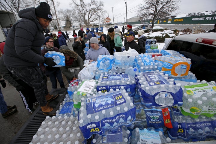 Volunteers distribute bottled water to help combat the effects of the crisis when the city's drinking water became contaminated with dangerously high levels of lead in Flint, Michigan.