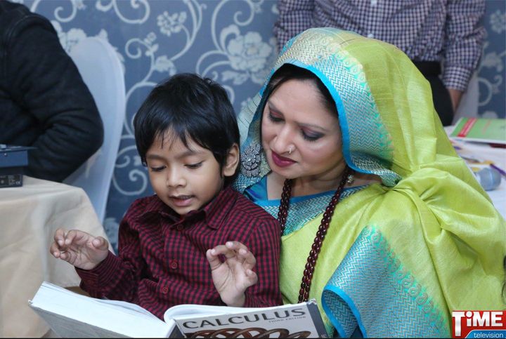 While everyone was enjoying the food and music after the reception, Isaac sat with Nargis Ahmed, president of the Bangladesh Society, doing what else? Solving a calculus problem, Here