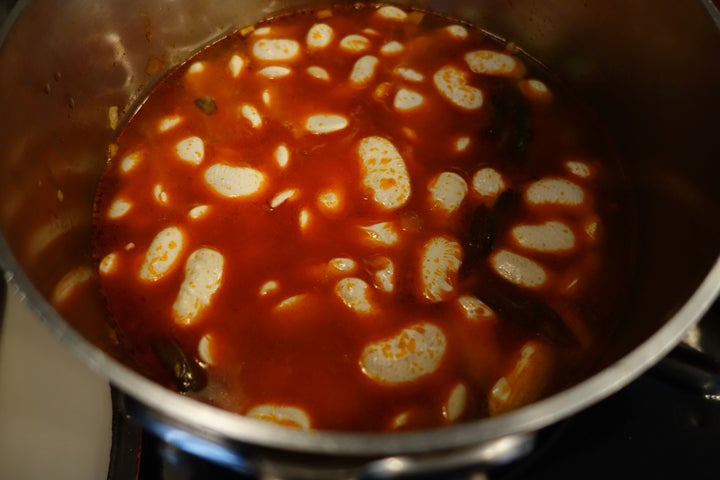 <p>The chilies in the ’nduja turn the water bright red</p>