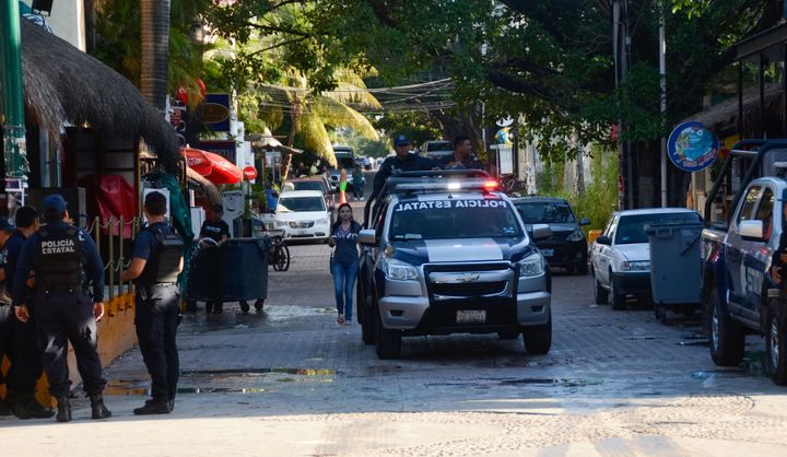 Mexican police agents patrol near a nightclub in Playa del Carmen, Quintana Roo state, Mexico where 5 people were killed, three of them foreigners, during a music festival on January 16, 2017. (STR/AFP/Getty Images)