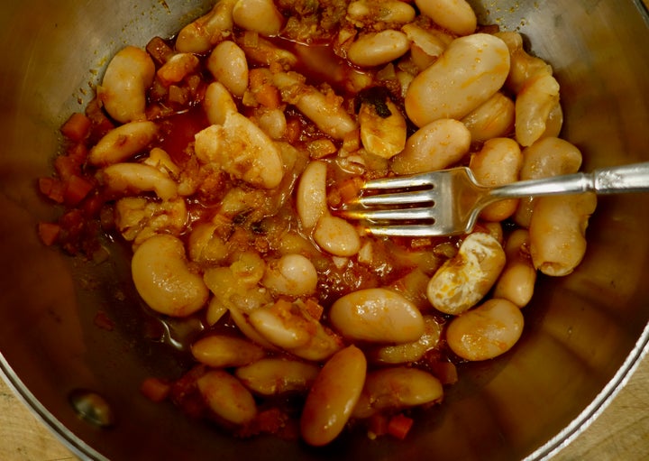 <p>Coarsely mashing beans for the hake: the spicy option</p>