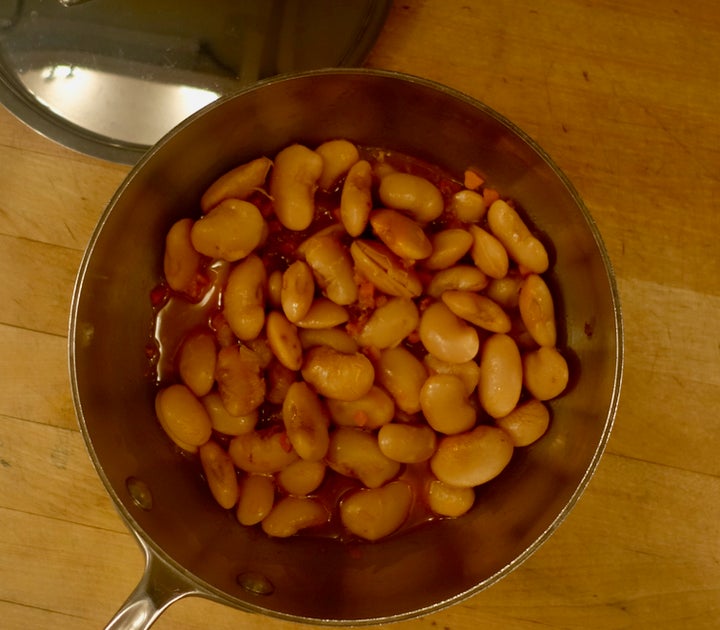 Beans heated in sauce from braised pork belly