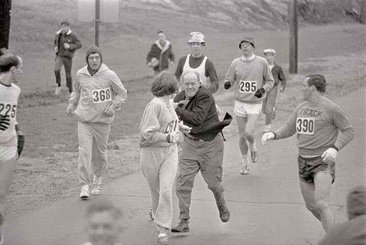 Trainer Jock Semple (in street clothes) enters the field of runners to try to pull Kathy Switzer out of the race.