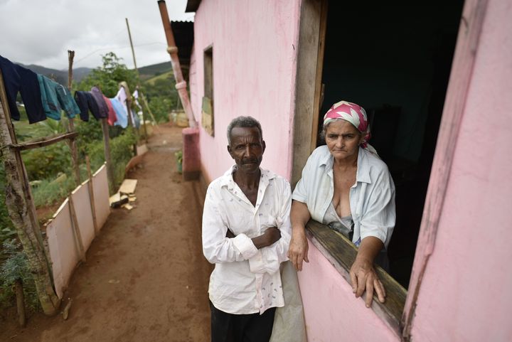 Pedro Joel de Oliveira and Teresinha Gomes de Oliveira, the parents of a victim of suspected yellow fever, stand at their home in the southeastern Brazilian state of Minas Gerais on Friday. Health authorities of Minas Gerais decreed a health emergency in 152 cities and towns due to a likely outbreak of yellow fever.