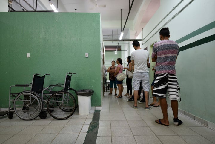 People line up to receive the yellow fever vaccine at a public health post in Caratinga, in the southeastern state of Minas Gerais, Brazil, on Friday.