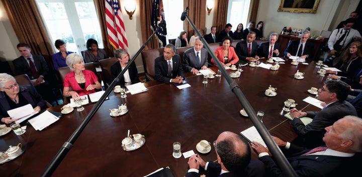 U.S. President Barack Obama (C) makes briefs remarks to the news media at the beginning of a cabinet meeting. White House Chief of Staff Denis McDonough is in the upper right.